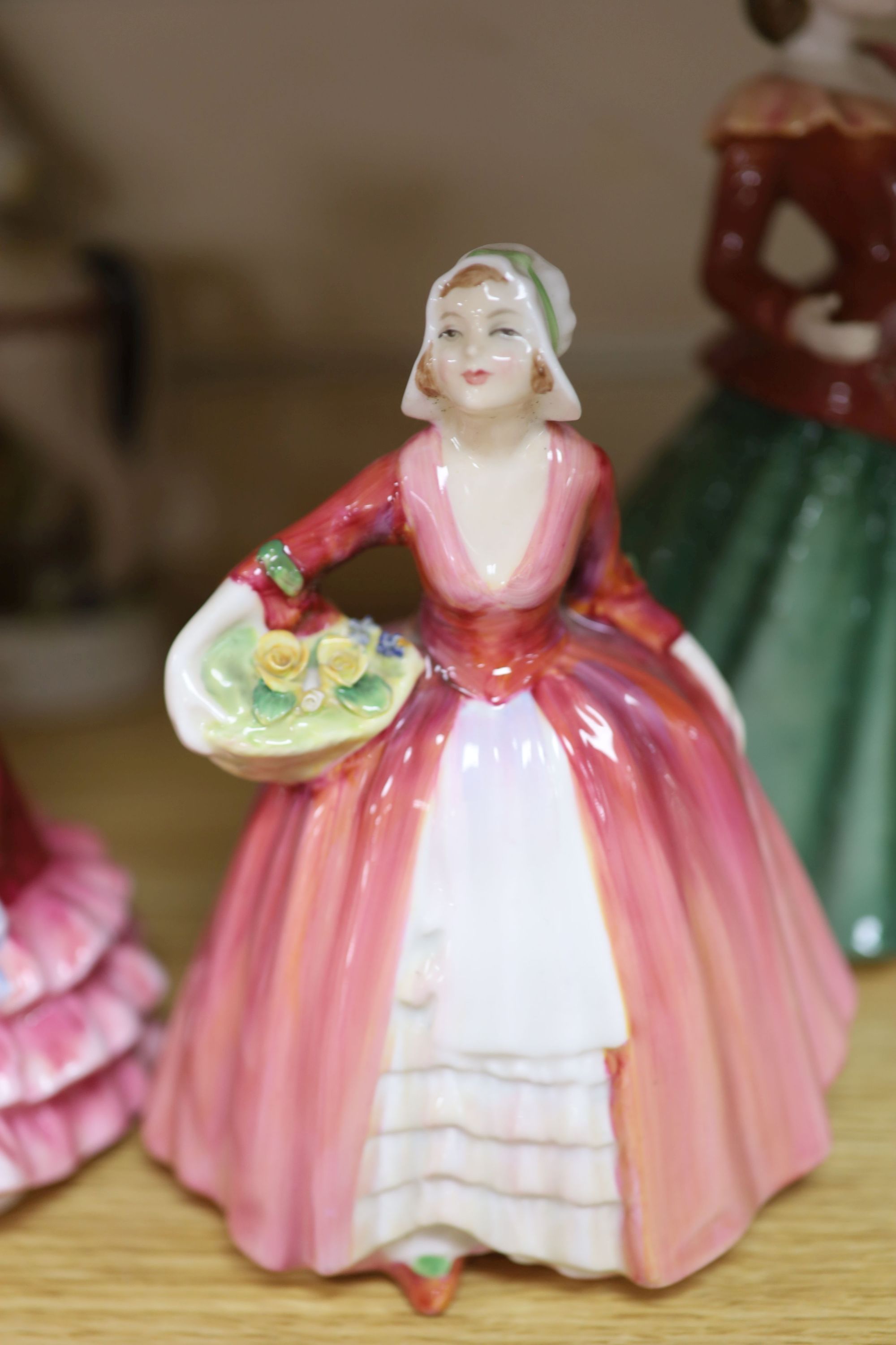 Five Royal Doulton porcelain ladies, two Coalport, one Worcester, another porcelain lady and a Staffordshire figure